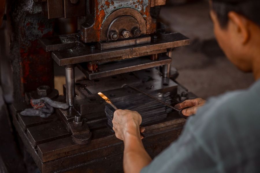 Worker operating a stamping press